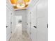 Hallway view features wood floors, white walls, recessed lighting, and access to multiple rooms at 8234 Midnight Pass Rd, Sarasota, FL 34242