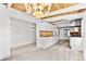 Bright kitchen featuring modern cabinets, stainless steel appliances, stylish backsplash and wood-beamed ceiling with decorative lighting at 8234 Midnight Pass Rd, Sarasota, FL 34242