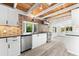Bright kitchen features modern appliances, white cabinets, striking backsplash, and wood plank ceiling at 8234 Midnight Pass Rd, Sarasota, FL 34242
