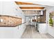 Sleek, modern kitchen with wood-look tile backsplash, stainless steel appliances, and wood-look ceiling at 8234 Midnight Pass Rd, Sarasota, FL 34242