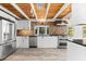 Bright kitchen featuring stainless steel appliances, geometric backsplash, and modern white cabinets at 8234 Midnight Pass Rd, Sarasota, FL 34242