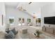 Bright living room boasting high ceilings, ceiling fans, and access to a pool at 8234 Midnight Pass Rd, Sarasota, FL 34242