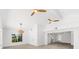 Bright living room boasts wood floors, two fans, vaulted ceilings, and view to the hallway at 8234 Midnight Pass Rd, Sarasota, FL 34242