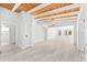 Open-concept home with wood plank ceilings, modern chandelier, and expansive living area at 8234 Midnight Pass Rd, Sarasota, FL 34242