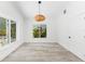 Bright living room features wood floors, white walls, natural lighting, and modern door and window trim at 8234 Midnight Pass Rd, Sarasota, FL 34242