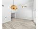 Bright living room features wood floors, an ornamental light fixture and view to the kitchen at 8234 Midnight Pass Rd, Sarasota, FL 34242