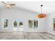 Open-concept living room with high ceilings and views of outdoor pool at 8234 Midnight Pass Rd, Sarasota, FL 34242