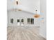 Bright living room boasts vaulted ceilings, wood-look floors, and a view of the pool at 8234 Midnight Pass Rd, Sarasota, FL 34242