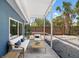 Relaxing screened patio with comfortable seating and stylish decor perfect for enjoying the outdoors at 8234 Midnight Pass Rd, Sarasota, FL 34242