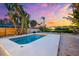 Backyard pool and lounge area at sunset, surrounded by mature tropical landscaping at 8234 Midnight Pass Rd, Sarasota, FL 34242