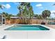 Backyard pool area with clear turquoise water, deck, and tropical landscaping at 8234 Midnight Pass Rd, Sarasota, FL 34242