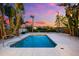 Backyard pool and lounge area, surrounded by mature tropical landscaping at 8234 Midnight Pass Rd, Sarasota, FL 34242