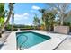 Backyard pool featuring sparkling turquoise water, surrounded by lush landscaping and a wooden deck at 8234 Midnight Pass Rd, Sarasota, FL 34242