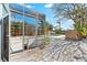 Spacious screened-in porch with view of pool and backyard at 8234 Midnight Pass Rd, Sarasota, FL 34242