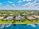 Beautiful aerial view of waterfront homes, mature trees, and well-maintained lawns at 8930 Bloomfield Blvd, Sarasota, FL 34238