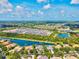 Expansive aerial view of waterfront homes, lush landscapes, and community lake at 8930 Bloomfield Blvd, Sarasota, FL 34238