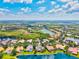 Breathtaking aerial perspective of waterfront homes lining the serene lake community at 8930 Bloomfield Blvd, Sarasota, FL 34238