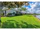 Beautiful backyard with lush green grass and serene lake view, perfect for relaxation at 8930 Bloomfield Blvd, Sarasota, FL 34238