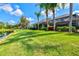 Expansive backyard featuring lush lawn, mature trees, and tranquil pond views at 8930 Bloomfield Blvd, Sarasota, FL 34238