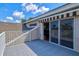 Open balcony with awning and tile flooring at 8930 Bloomfield Blvd, Sarasota, FL 34238