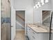 Bathroom featuring granite countertops, white cabinets, shower with glass door, and tile floors at 8930 Bloomfield Blvd, Sarasota, FL 34238