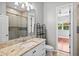 Bathroom featuring a large vanity, walk-in shower, and view into bedroom at 8930 Bloomfield Blvd, Sarasota, FL 34238