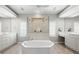 Bright bathroom with a soaking tub, double vanities, and a large walk-in shower at 8930 Bloomfield Blvd, Sarasota, FL 34238