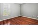 Bedroom featuring hardwood floors, neutral walls, and white window shutters at 8930 Bloomfield Blvd, Sarasota, FL 34238