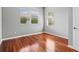 Bedroom with hardwood floors and natural light from two windows with blinds at 8930 Bloomfield Blvd, Sarasota, FL 34238