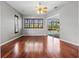 Sun-filled bedroom with hardwood floors, plantation shutters, and pool view at 8930 Bloomfield Blvd, Sarasota, FL 34238
