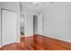 Spacious bedroom featuring hardwood floors, neutral walls, ceiling fan, and ensuite bathroom at 8930 Bloomfield Blvd, Sarasota, FL 34238