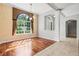 Open dining area with hardwood floors, archway, view of the entrance and lots of natural light at 8930 Bloomfield Blvd, Sarasota, FL 34238