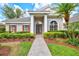 Welcoming entrance featuring a paver walkway, vibrant landscaping, and an inviting front door at 8930 Bloomfield Blvd, Sarasota, FL 34238
