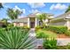 Attractive home with a stone walkway, verdant landscaping, and a well-maintained lawn at 8930 Bloomfield Blvd, Sarasota, FL 34238