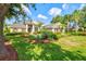 Beautiful home featuring a well-manicured lawn, lush landscaping, and mature trees at 8930 Bloomfield Blvd, Sarasota, FL 34238