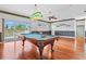 Spacious game room with pool table, bar area, and outdoor access at 8930 Bloomfield Blvd, Sarasota, FL 34238