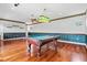 Spacious game room features a billiard table, wood floors and wainscotting at 8930 Bloomfield Blvd, Sarasota, FL 34238