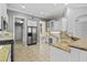 Bright kitchen features stainless steel appliances, granite countertops, and a functional desk area at 8930 Bloomfield Blvd, Sarasota, FL 34238