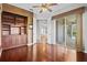 Living area with hardwood floors, custom built-ins, and sliding door to the patio at 8930 Bloomfield Blvd, Sarasota, FL 34238