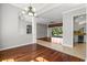 Spacious living area with hardwood flooring flowing into additional living and kitchen areas at 8930 Bloomfield Blvd, Sarasota, FL 34238