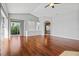 Open living room with hardwood floors, neutral paint, and natural light at 8930 Bloomfield Blvd, Sarasota, FL 34238