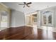 Inviting living room features hardwood floors and an arched entry leading to the dining area at 8930 Bloomfield Blvd, Sarasota, FL 34238
