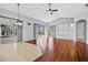 Bright living room features hardwood floors, ceiling fan, and sliding glass doors to outdoor space at 8930 Bloomfield Blvd, Sarasota, FL 34238