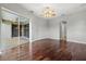 Spacious main bedroom with hardwood floors, mirrored closet, and ensuite bathroom at 8930 Bloomfield Blvd, Sarasota, FL 34238