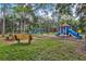 Outdoor park playground with slides, benches, and lush greenery at 8930 Bloomfield Blvd, Sarasota, FL 34238