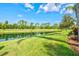 Scenic pond view with lush landscaping, creating a peaceful and inviting outdoor space at 8930 Bloomfield Blvd, Sarasota, FL 34238
