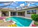 Beautiful in-ground pool features a spa and ample seating, perfect for outdoor entertaining at 8930 Bloomfield Blvd, Sarasota, FL 34238
