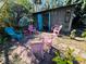 Charming backyard shed features a patio with colorful chairs, perfect for outdoor relaxation and entertaining at 1019 10Th W Ave, Bradenton, FL 34205