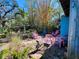 Backyard view features colorful patio chairs and lush bamboo trees at 1019 10Th W Ave, Bradenton, FL 34205