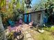 Charming backyard shed features a patio with colorful chairs, perfect for outdoor relaxation and entertaining at 1019 10Th W Ave, Bradenton, FL 34205